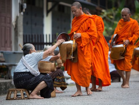 The tak bat, morning alms of Buddhist monks' morning collection of food in Luang Prabang